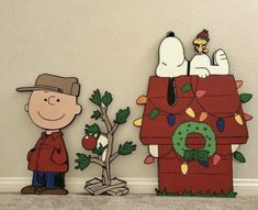 a charlie brown christmas scene with peanuts and his doghouse made out of cardboard paper