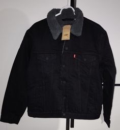 Elevate your style with this iconic Levi's Trucker Sherpa Fleece Lined  Jacket, perfect for a casual or travel occasion. The jacket features a snap closure and is made of 100% cotton outer shell material, making it both breathable and comfortable. The jacket is lined with polyester, providing warmth during the winter and spring seasons. With a black color and a classic TRUCKER character, this jacket is a must-have for any men's wardrobe. It is a regular fit jacket with a chest size of 44 inches, Black Corduroy Jacket, Fleece Lined Jacket, Black Jean Jacket, Men's Wardrobe, Corduroy Jacket, Line Jackets, Workout Jacket, Sherpa Fleece, Levis Men