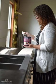 a woman holding a container of ice cream