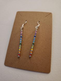 A pair of handmade rainbow drop earrings, ready to add a splash of color. Rainbow Hypoallergenic Earrings As Gift, Nickel-free Rainbow Earrings Gift, Nickel-free Rainbow Earrings For Gift, Rainbow Nickel-free Earrings For Gifts, Adjustable Rainbow Earrings As Gift, Rainbow Drop Earrings For Pierced Ears, Colorful Hypoallergenic Dangle Jewelry, Hypoallergenic Multicolor Sterling Silver Earrings, Rainbow Drop Earrings As A Gift