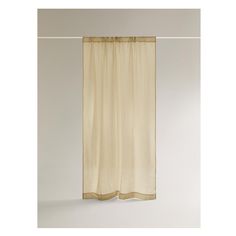 a white curtain hanging on the side of a wall