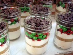 several jars filled with desserts on top of a table