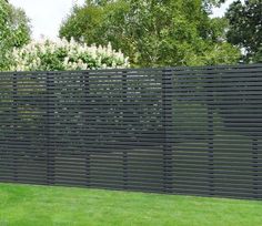 a black fence in the middle of some grass