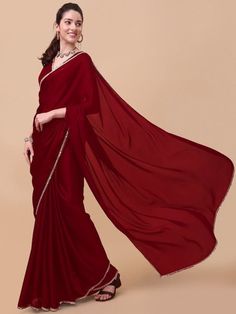 Maroon and gold-toned sareeSolid solid saree with embellished border borderHas mirror work detailThe saree comes with an unstitched blouse pieceThe blouse worn by the model might be for modelling purpose only. Check the image of the blouse piece to understand how the actual blouse piece looks like. Eid Puja Pre-draped Saree With Embroidered Border, Party Wear Pre-draped Chanderi Saree With Embroidered Border, Bollywood Pre-draped Saree With Embroidered Border, Diwali Georgette Blouse Piece With Embroidered Border, Sheer Dupatta Chinon Saree For Diwali, Anarkali Pre-draped Saree With Embroidered Border For Party, Chinon Blouse Piece For Eid, Navratri Saree Blouse With Embroidered Border, Designer Pre-draped Saree With Embroidered Border