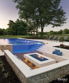 an outdoor fire pit next to a swimming pool