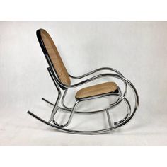 a metal rocking chair with wooden seat and armrests, on a white background