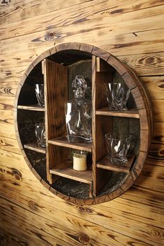 a round wooden shelf with glasses on it