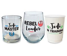 three glasses with different designs on them sitting next to each other in front of a white background