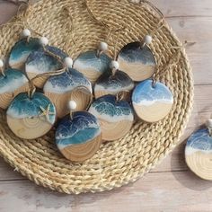 small ceramic ornaments are sitting on a wicker basket next to some string and beads