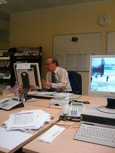 a man sitting at a desk in front of a computer