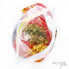 a plastic bag filled with food on top of a white table