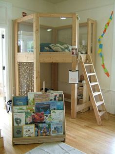 there is a bunk bed in the middle of this room with a ladder to it