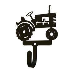 a tractor is mounted to the side of a metal wall hanging on a white background