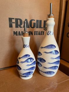 two blue and white vases with fish on them