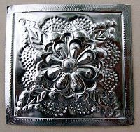 a metal square with an intricate design on it