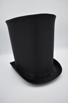 This season complete your look with this Extra Tall Satin Top Hat in Black. Featuring a black top hat that stands approximately 10 inches tall. Perfect for Halloween, Cosplay, Theater, Prom and More! Each magician hat is sized about 50cm - 57 cm or 22.4 inches in circumference and includes a sweatband. This satin top hat has a matching satin band that rounds the base of the hat accented with a upturned brim on the sides. Ringmaster top hat is about 11.5 inches long and 9.5 inches wide. *Inside of hat does not extend to the top. There is a "false" top layer.*  Great for Men and Women! This hat is great for many purposes including Steampunk, Victorian, Theatrical use, Formal occasions, weddings, Coachman, Jack the Ripper, Ring Master, and more. For ages 14 and older. Spot clean only. One siz Victorian Prom, Magician Hat, Black Satin Top, Ring Master, Tall Hat, Sewing Equipment, Black Top Hat, Steampunk Victorian, Bill Cipher