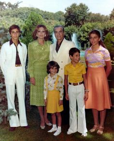 an old photo of a family posing in front of a fountain