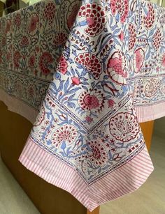 an image of a table cloth on top of a wooden stand in a room with tile flooring