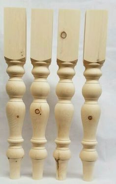 four wooden candlesticks are lined up against a white background with holes in them