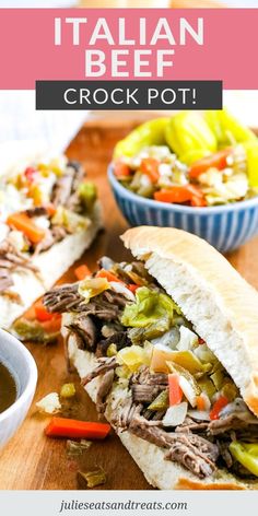 an italian beef crock pot sandwich on a cutting board with dipping sauce in the background