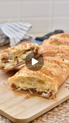 a wooden cutting board topped with pastries on top of a counter