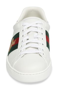 Signature web stripes and bold embroidery bring together two of Gucci's most distinctive house codes on this classic leather sneaker. Contrasting heel tabs are a modern reference to the brand's official colors. Style Name:Gucci New Ace Sneaker (Men). Style Number: 5415061. Gucci Lace-up Sneakers With Logo Detail, Luxury Gucci Sneakers With Embroidered Logo, Designer Gucci High-top Sneakers With Embroidered Logo, Gucci Designer High-top Sneakers With Embroidered Logo, Gucci Leather High-top Sneakers With Embroidered Logo, Gucci Leather Sneakers With Embroidered Logo, Sporty Gucci Sneakers With Logo Detail, Gucci Sporty Sneakers With Logo Detail, White Sneakers With Signature Stripes For Streetwear