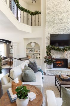 a living room filled with furniture and a flat screen tv mounted on the wall above a fireplace