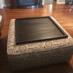 a large ottoman sitting on top of a hard wood floor