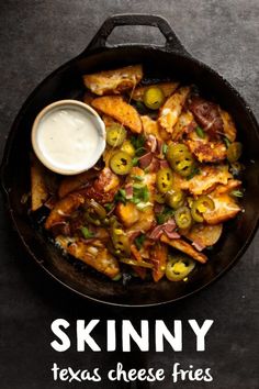 a skillet filled with chicken, olives and ranch dressing