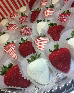 chocolate covered strawberries and candy canes are arranged on a platter for display