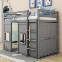 a gray bunk bed with built in bookshelves and drawers on the bottom shelf