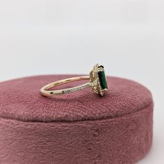 This ring features a beautiful emerald set in a halo ring setting with sparkling natural diamonds all set in 14k solid yellow gold. This design features two tapered baguette diamond accents in the shank. A gorgeous modern look that's perfectly balanced between minimalist and glamour. Halo Ring Setting, Emerald Set, Designer Silver Jewellery, Semi Mount Ring, Jewelry Showcases, Ring Setting, Halo Ring, Baguette Diamond, Earring Findings