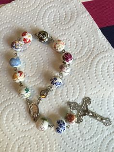 a rosary with a cross on it sitting on top of a white doily covered table