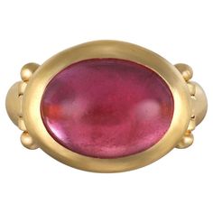 Faye Kim's 22 Karat Gold Pink Tourmaline Hinged Ring, with its oversize stone, spectacular berry hue and half round shank, is beautifully bezel set and matte finished. The ring can be worn for any occasion. Tourmaline 10 Carats Bezel length x width 20 x 16mm Tapered shank width 6mm to 4mm Size 8, can be sized Made in the USA Pink Tourmaline Cabochon Ring, Hinged Ring, Ring Ring, Bezel Ring, Contemporary Ring, Pink Ring, Purple Hues, Topaz Ring, Bezel Setting