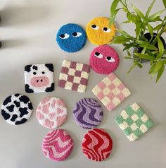 several knitted objects sitting on top of a table next to a plant