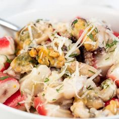 a white bowl filled with pasta and vegetables