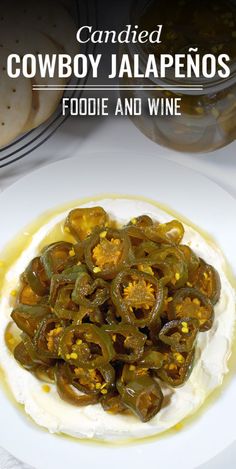 a white plate topped with food covered in cheese and jalapenos on top of mashed potatoes