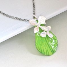 "Real Orchid Petal Necklace - Real Orchid Petal dyed Green, preserved in resin. Two Silver Plated Orchids cascade down the orchid petal. The color is between lime green and mint green. Sterling Silver Chain and Findings Orchid Petal is approximately 1.5\" long x 1\" at widest point. Each orchid petal is unique. This is a stock photo. Be sure to check out my Floral Collection for similar items. http://www.etsy.com/shop/mcstoneworks?section_id=6939810" Nature-inspired Green Flower Necklaces, Green Flower Necklace Gift, Green Flower Necklace As Gift, Green Flower Necklace For Gift, Botanical Style Green Flower Jewelry, Woman Flower, Real Flower Necklace, Real Flower Jewelry, Botanical Jewelry