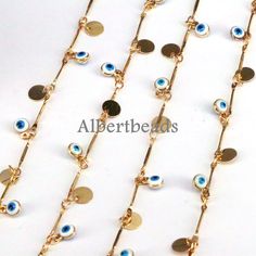 several gold chains with blue and white eyes on them