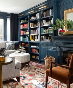 a living room with bookshelves and a dog laying on the floor in front of it