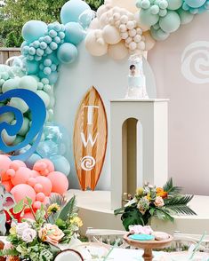 a surfboard themed birthday party with balloons and decorations