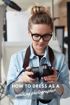 a woman holding a camera in her hands with the words how to dress as a wedding photographer