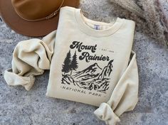 Love our National Parks? Pick up one of Mount Rainier National Park Sweatshirts for your next adventure! National Parks Sweatshirt, Cotton Adventure Sweatshirt With Letter Print, Winter Crew Neck Tops For Adventure, Fall Adventure T-shirt With Letter Print, Cotton Graphic Print Sweatshirt For Adventure, Port Angeles, Mount Rainier National Park, Rainier National Park, Sweat Shirts