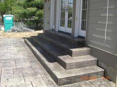 concrete steps leading to the front door of a house