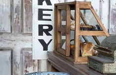 a shelf with bread and pastries on it in front of a sign that says bakery