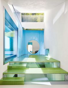 there are green steps leading up to the skylight in this modern house with blue walls