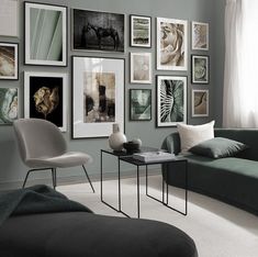 a living room filled with furniture and pictures on the wall