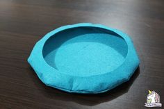 a blue bowl sitting on top of a wooden table