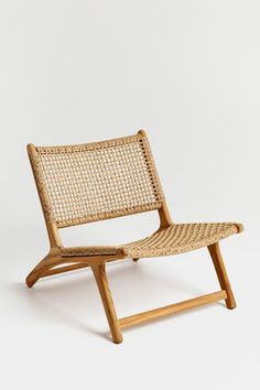 a chair made out of wood and wicker on a white background with no one around it