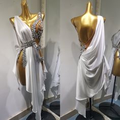 two mannequins dressed in white and gold with one draped over the other